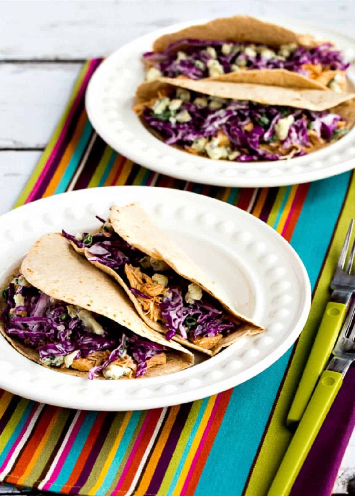 buffalo chicken tacos shown on two serving plates