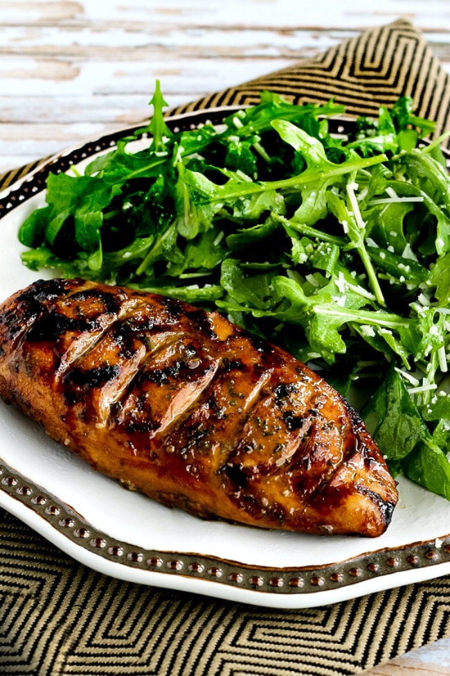 Grilled Chicken with Balsamic Vinegar close-up photo of chicken on plate with arugula salad.