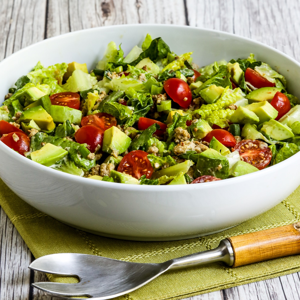 Ground Turkey Taco Salad with Salsa Verde shown in large white serving bowl.