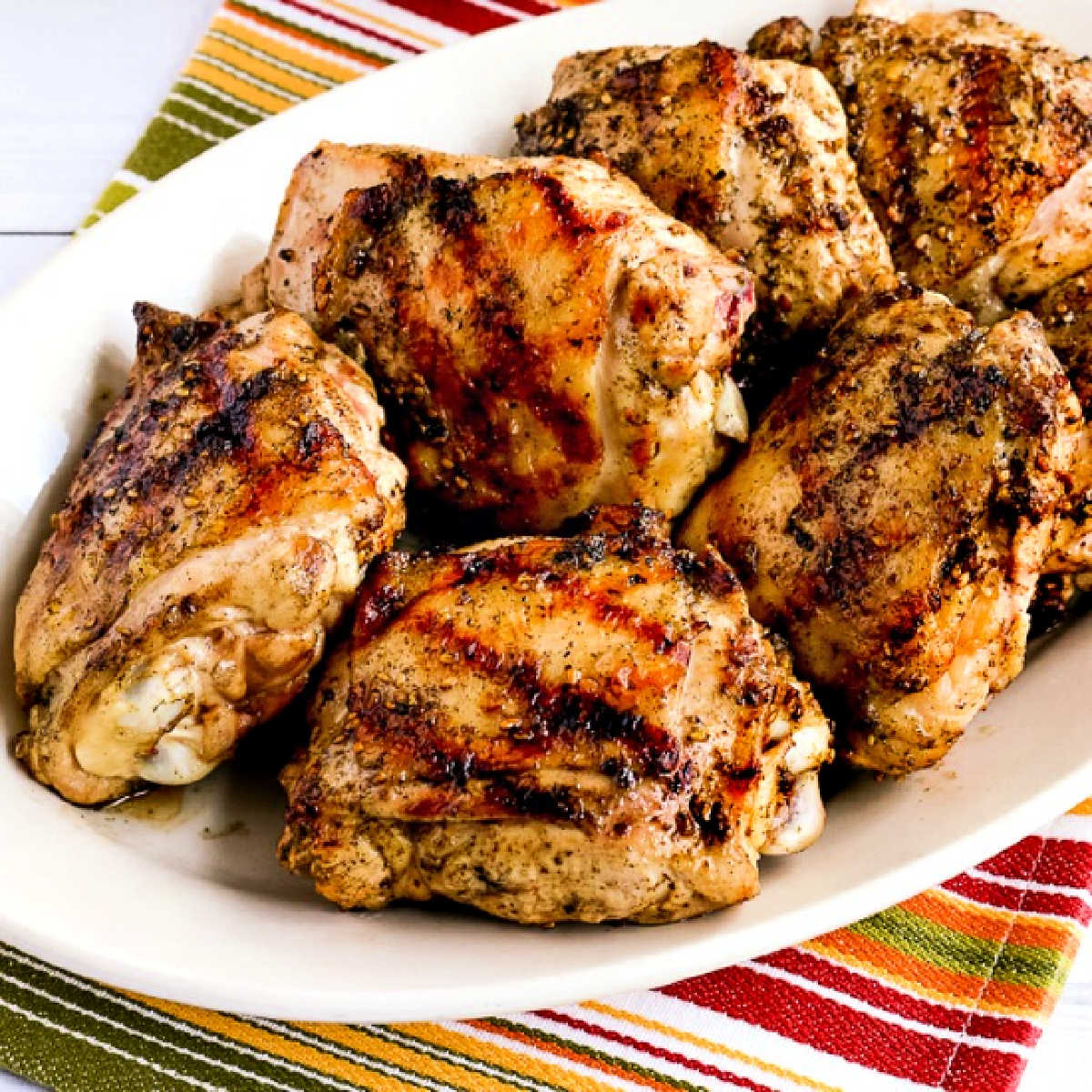 Grilled Chicken Thighs with Lemon and Za'atar square image of chicken on serving plate.