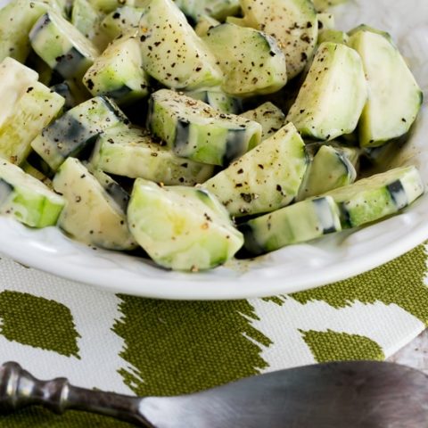 Cucumbers Caesar close-up shot in salad bowl with fork