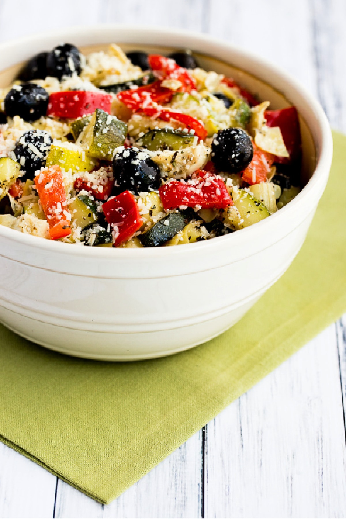 Marinated Zucchini Salad in serving bowl shown on green napkin