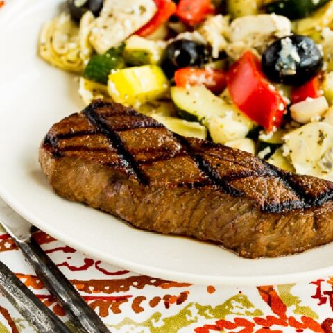 Carol's Easy Steak Marinade shown on serving plate with marinated zucchini salad