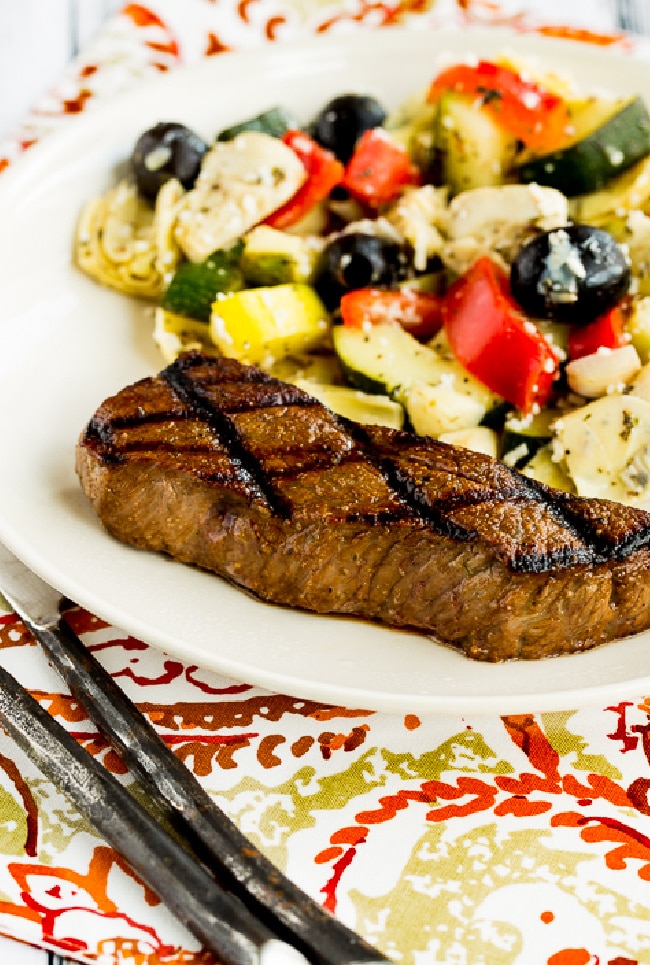 Carol's Easy Steak Marinade shown on serving plate with marinated zucchini salad