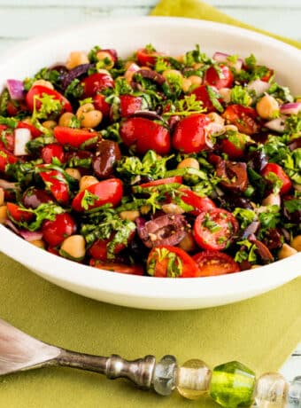 Chickpea Salad with Tomatoes and Olives shown in serving bowl.
