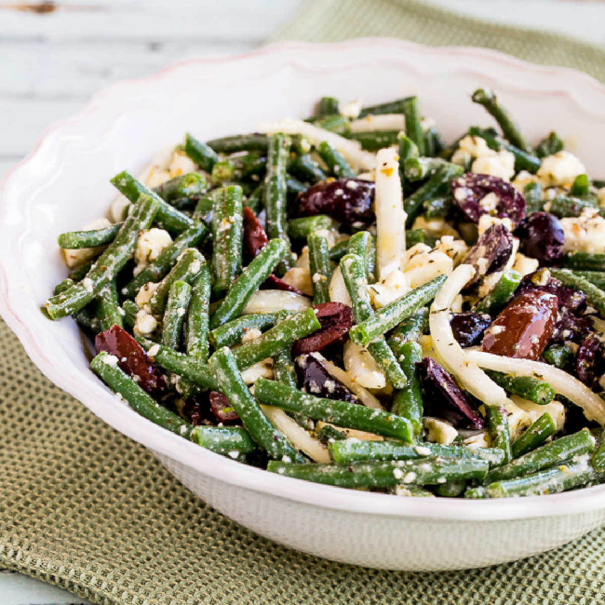 Green Bean Salad with Greek Olives and Feta shown in serving bowl.