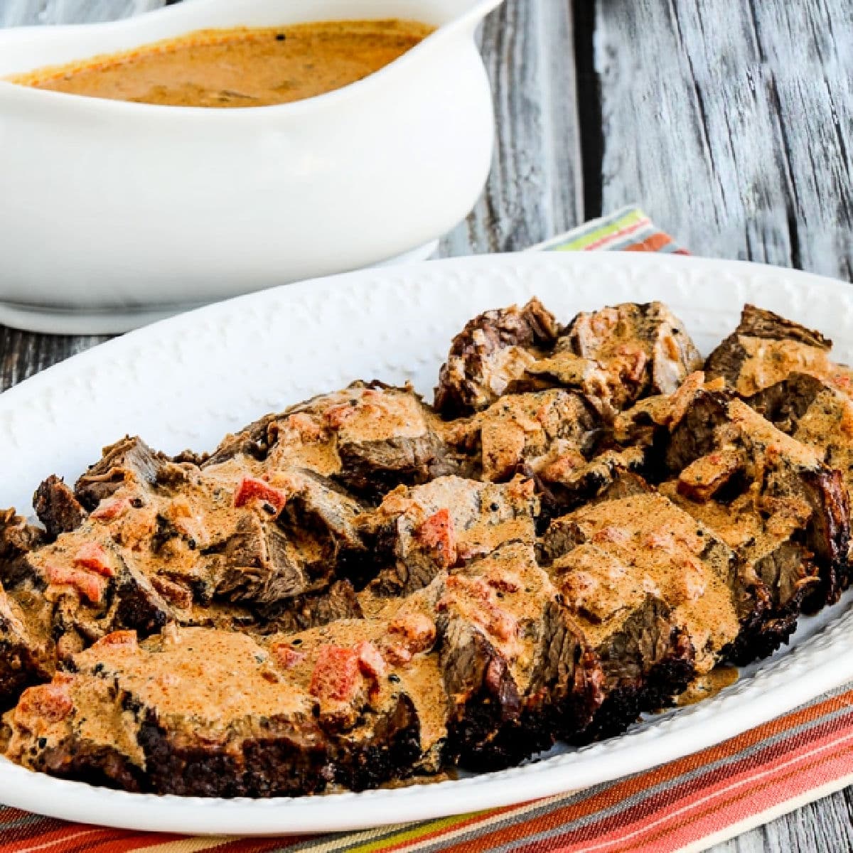 Square featured image for Slow Cooker Hungarian Pot Roast on serving plate with sauce in back.