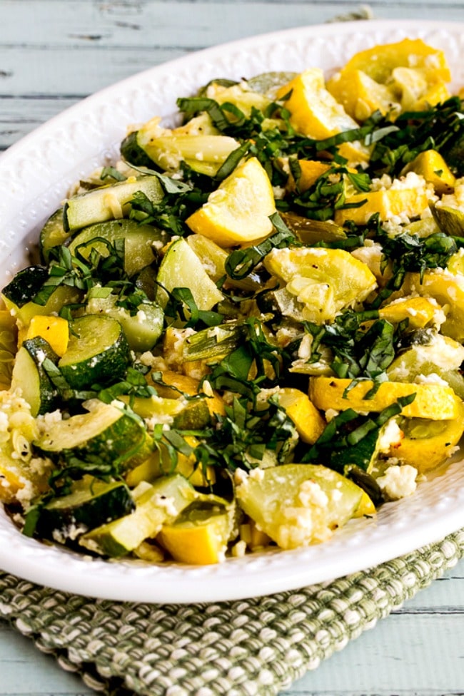 Roasted summer squash with feta cheese and basil close-up