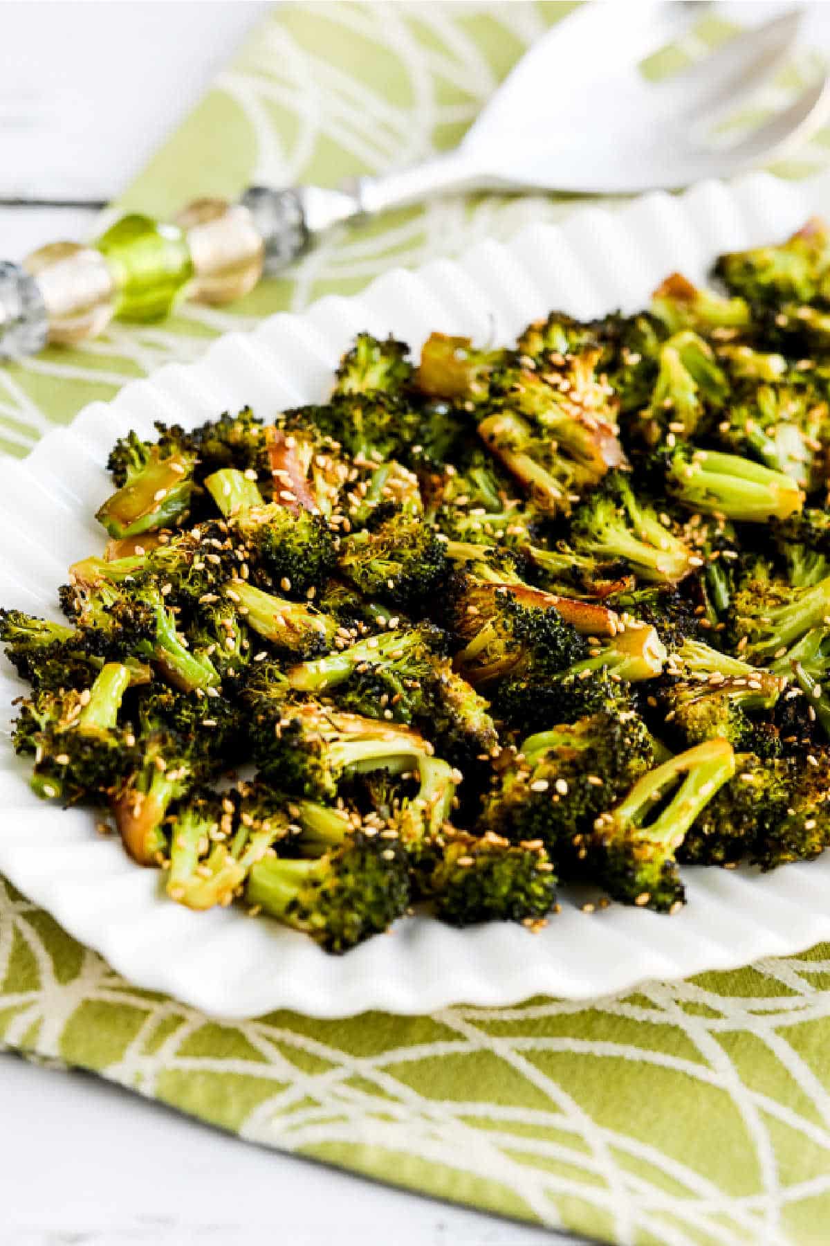 Quick Roasted Broccoli with Soy Sauce and Sesame on serving plate going across napkin