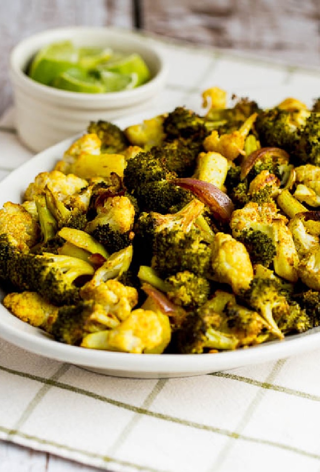 Roasted Broccoli and Cauliflower on serving dish with limes
