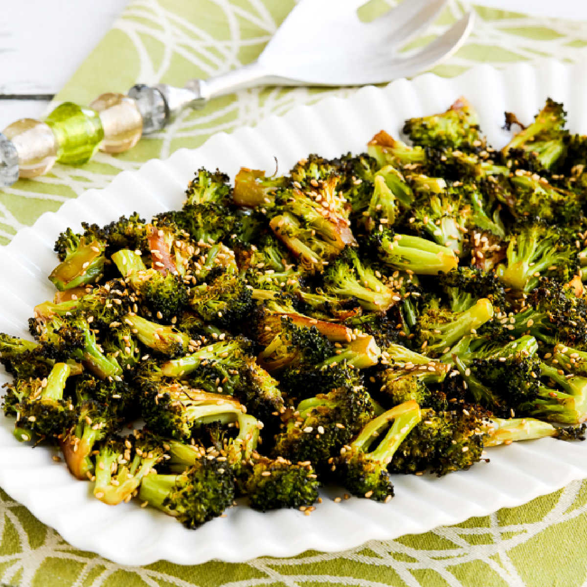 roasted broccoli with soy sauce and sesame seeds shown on serving plate