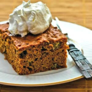 Square image of Apple Pear Cake shown on plate with whipped cream.