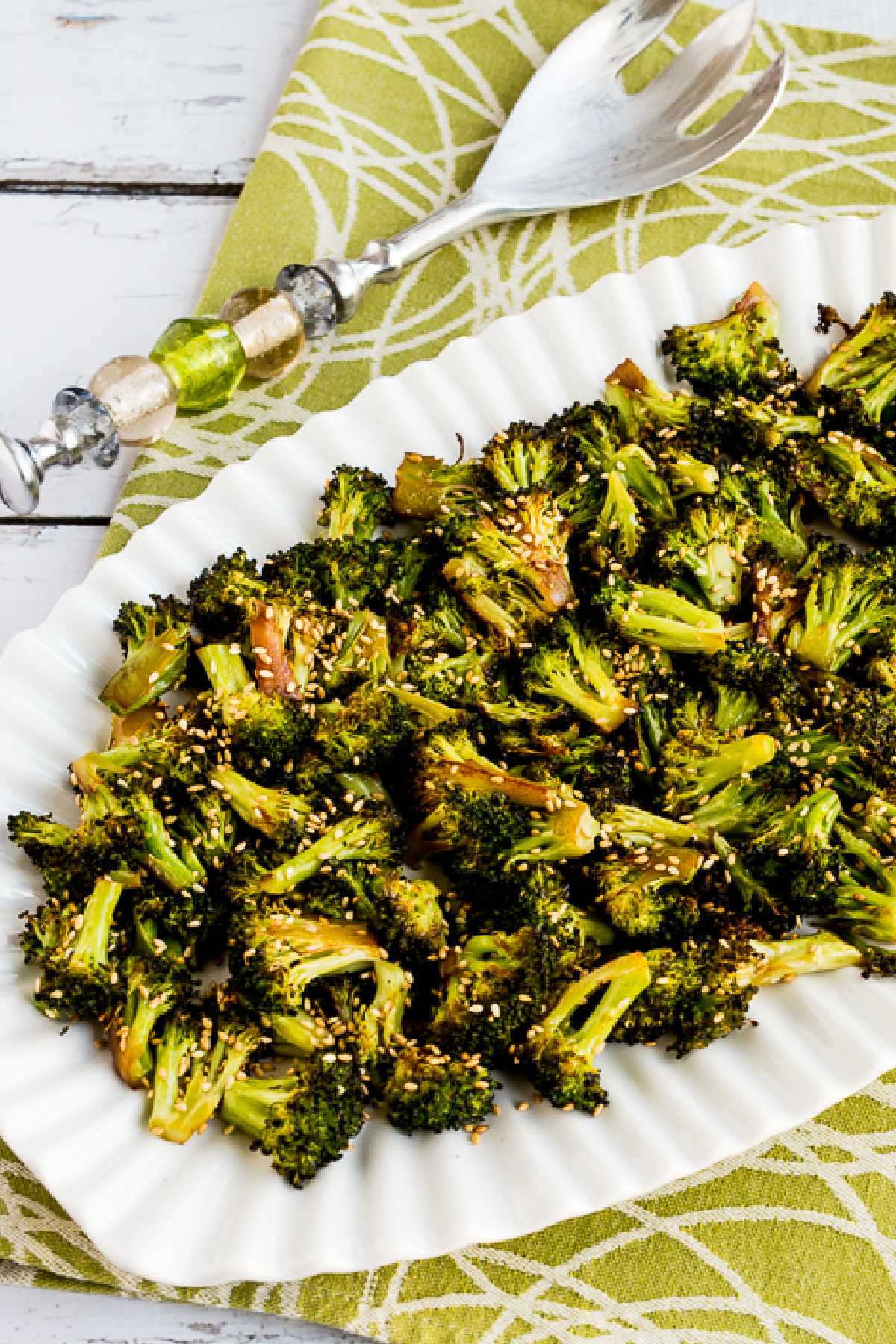 Quick roasted broccoli with soy sauce and sesame seeds on a serving plate