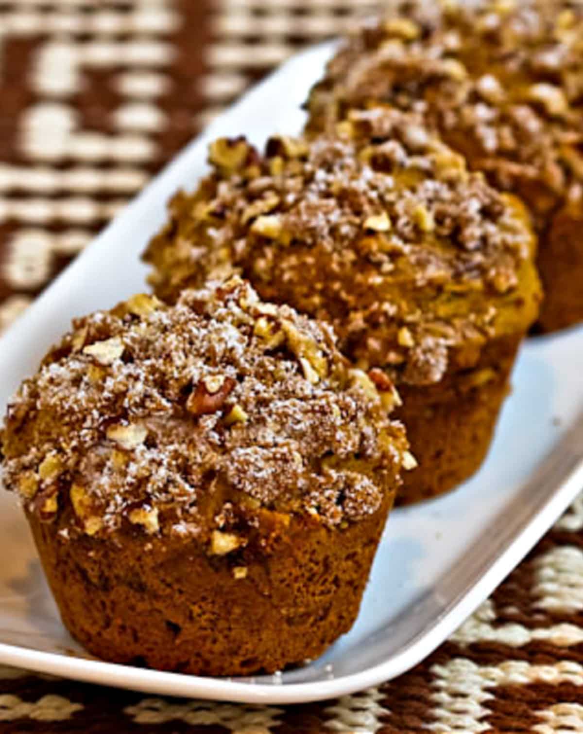 vertical photo of Sugar-Free Whole Wheat Pumpkin Muffins on small platter