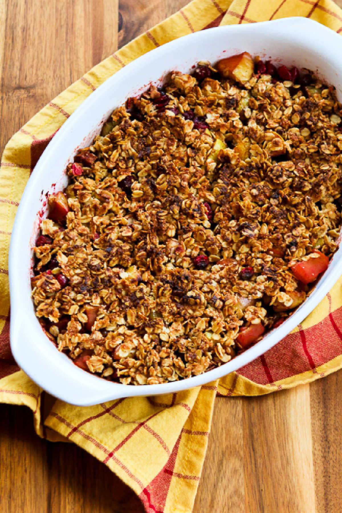 Cranberry Apple Crisp shown in baking dish with napkin