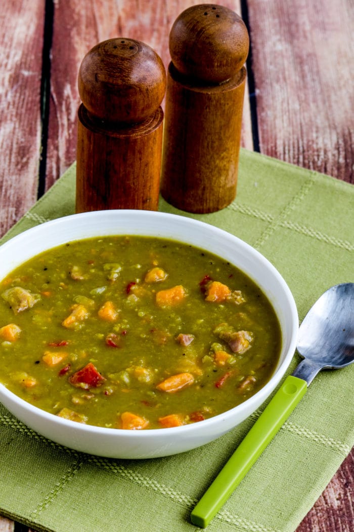Instant Pot Split Pea Soup shown in serving bowl with salt-pepper shakers in background.