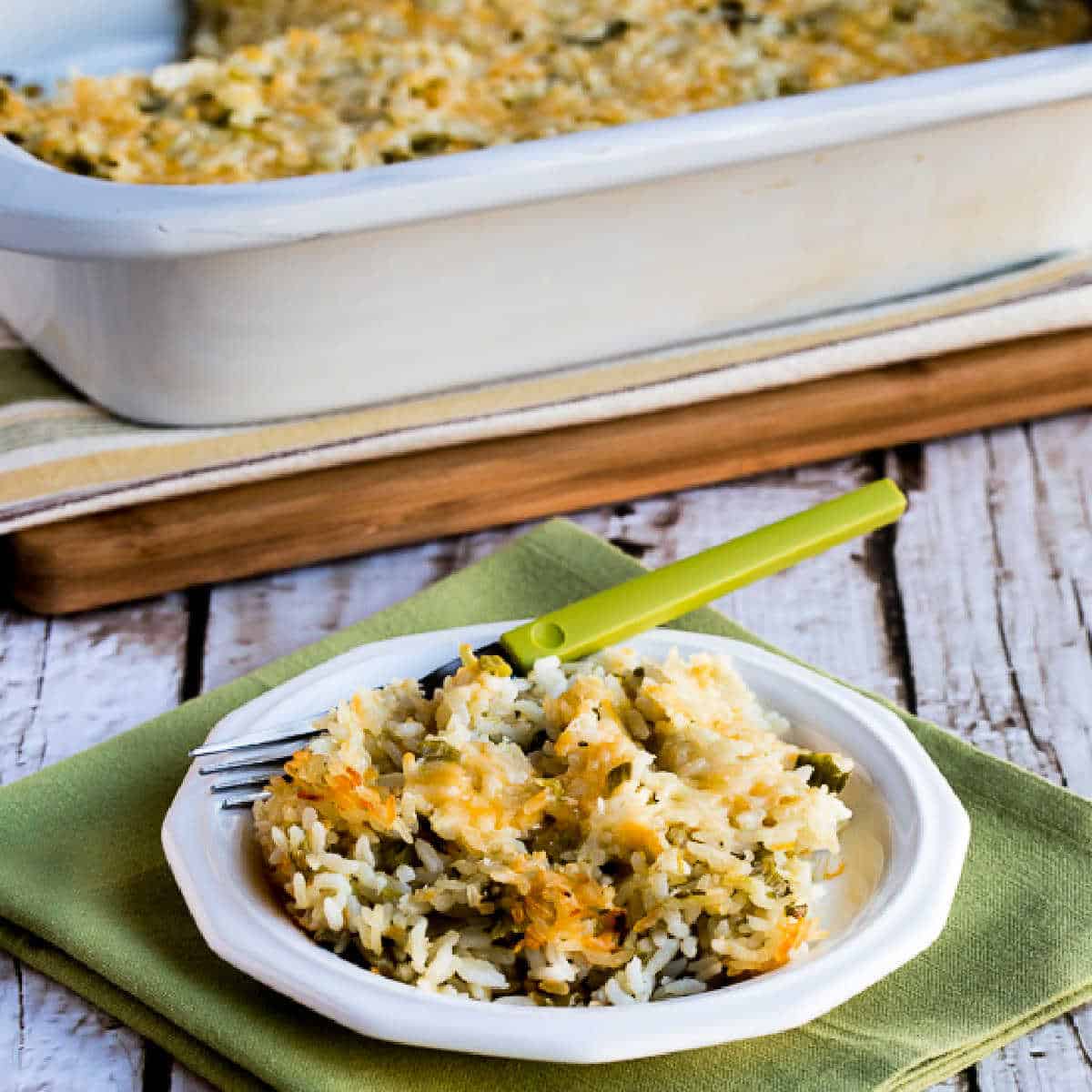 Slow Cooker Rice Casserole shown in casserole croc-pot with one serving on plate