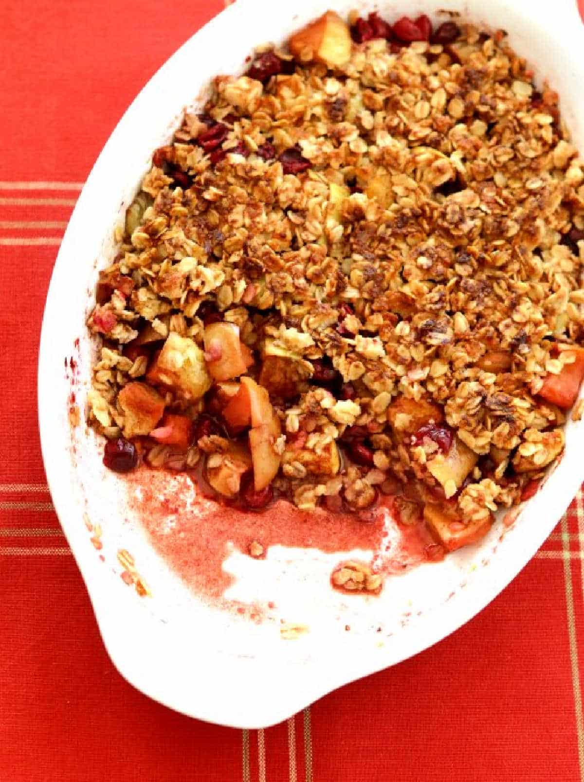 Cranberry Apple Crisp in baking dish with some eaten