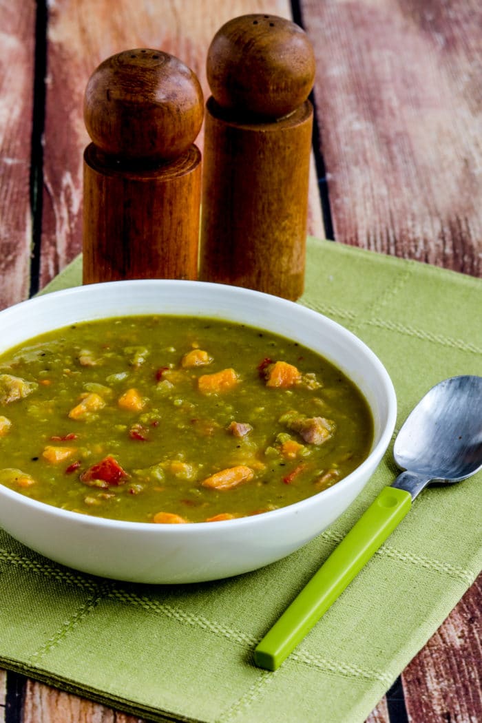 Instant Pot Split Pea Soup shown in serving bowl with salt-pepper shakers in background.