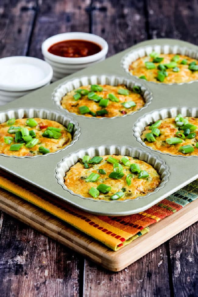 Southwestern Crustless Breakfast Tarts in tart pan with sour cream and salsa in back.