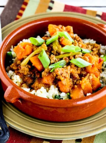 Square image of Turkey Sweet Potato Stew shown in serving bowl over cauliflower rice.