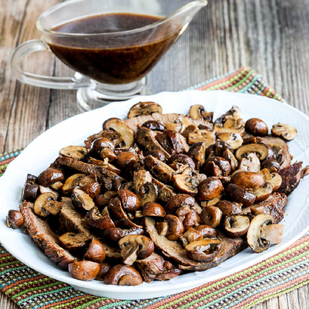 Square image of Slow Cooker Mushroom Lover's Pot Roast with pot roast on serving platter.