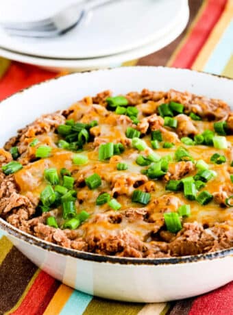 Square image of Instant Pot Refried Beans shown in serving bowl.