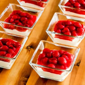 Square image for Low-Carb No Bake Cherry Cheesecake Dessert shown in individual square serving dishes.
