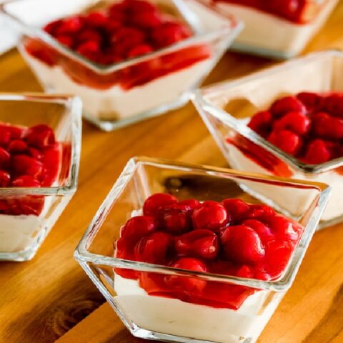 Low-Carb No Bake Cherry Cheesecake Dessert closer view of dishes filled with no-bake cheesecake on cutting board