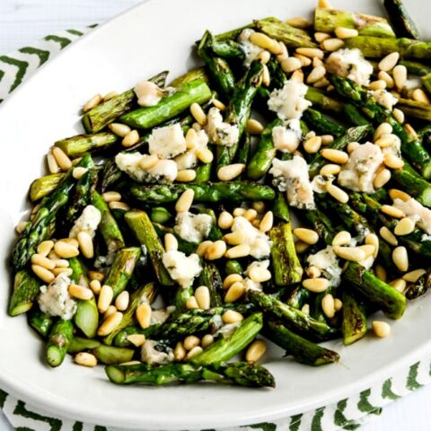 Sauteed Asparagus with Melted Gorgonzola and Pine Nuts close-up photo