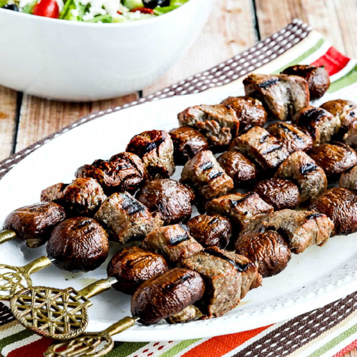 Steak Kabobs with Mushrooms shown on skewers on serving platter.