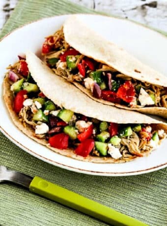Square image of Low-Carb Greek Pork Tacos, shown on serving plate with Greek Salsa.