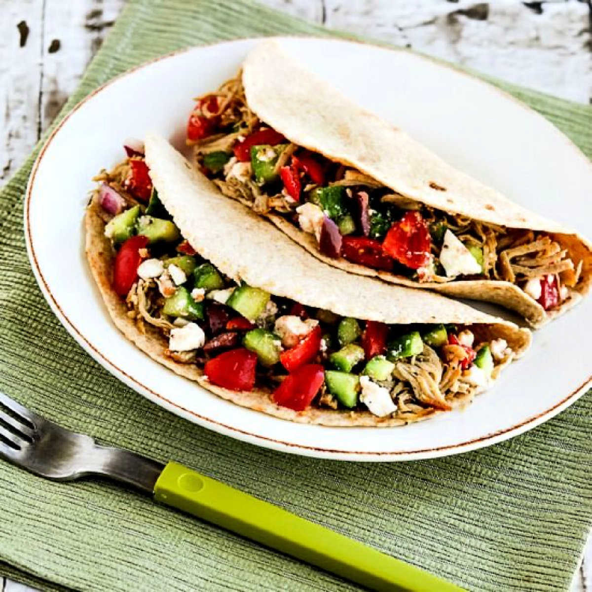 Square image of Low-Carb Greek Pork Tacos, shown on serving plate with Greek Salsa.