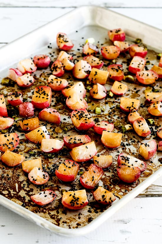 Roasted Radishes on sheet pan with black sesame seeds
