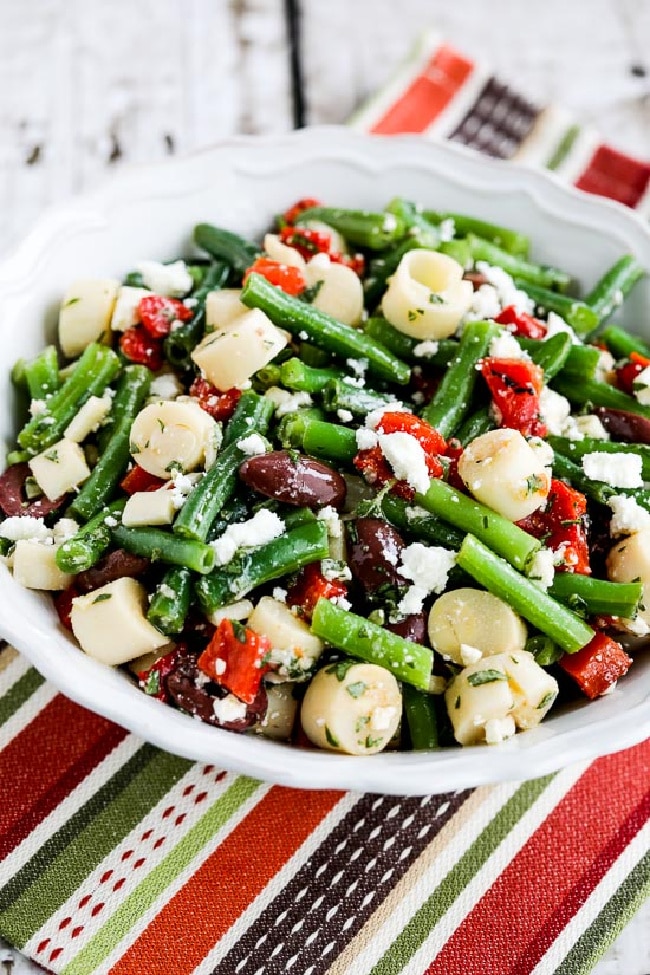 Green bean salad with palm hearts shown in a napkin serving bowl