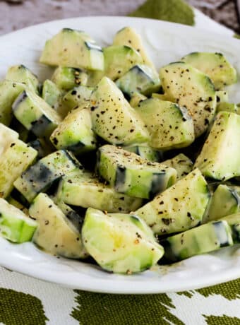 Square image for Cucumbers Caesar shown in salad bowl.