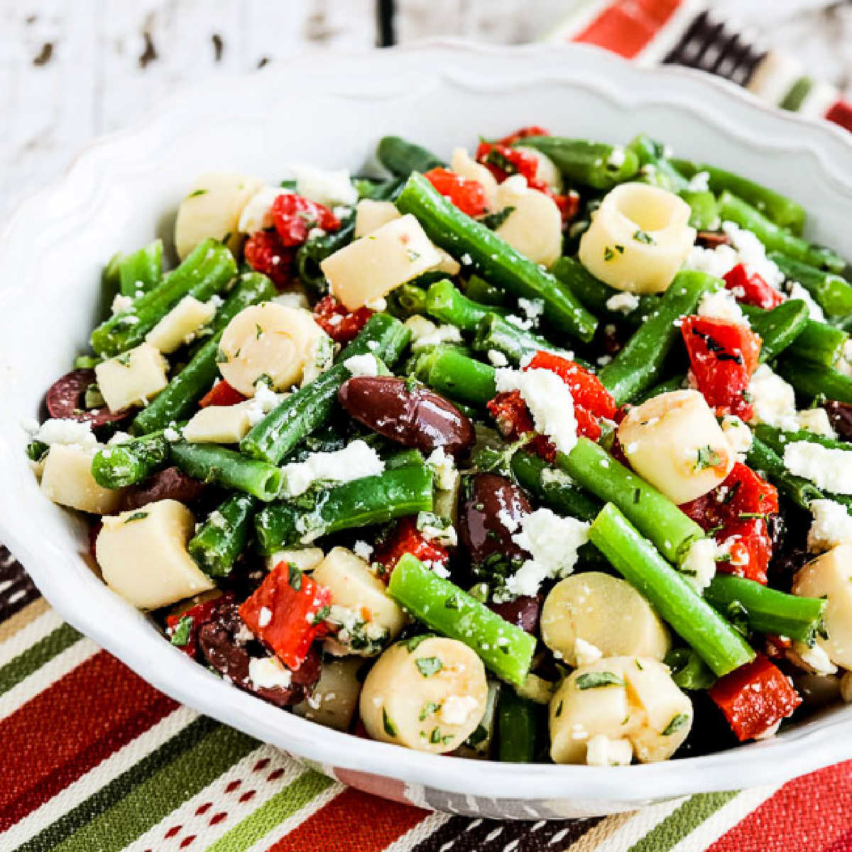 Green Bean Salad with Hearts of Palm square image of salad in serving bowl.