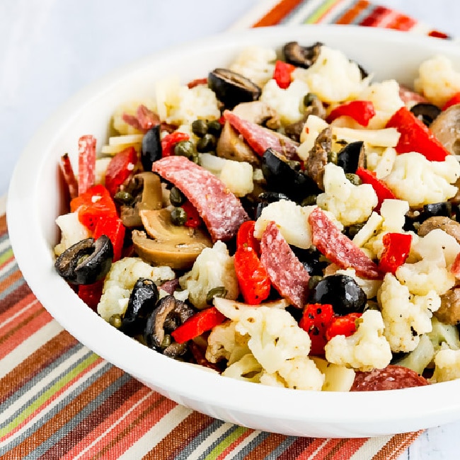 Marinated Cauliflower Antipasto Salad square image of salad in serving bowl with striped napkin