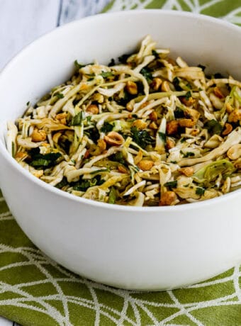 Spicy Cilantro-Peanut Slaw in serving bowl on green-white napkin