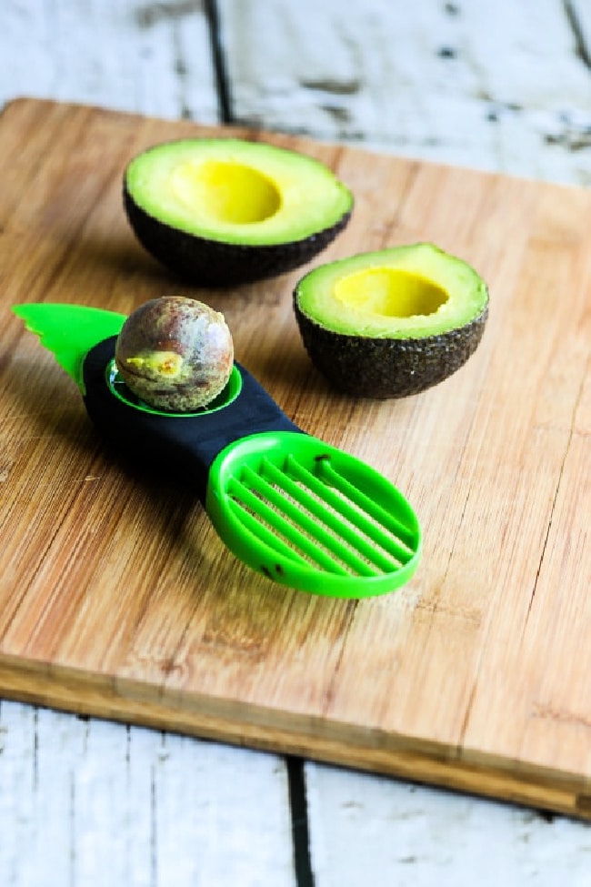 Image for Kalyn's Kitchen Picks: OXO Avocado Tool showing tool with avocado on cutting board.