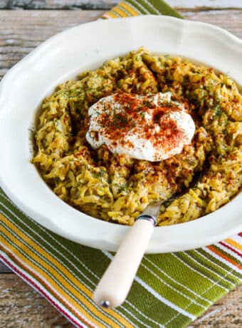 Square image of Al's Hungarian Recipe for Summer Squash shown in bowl on napkin.
