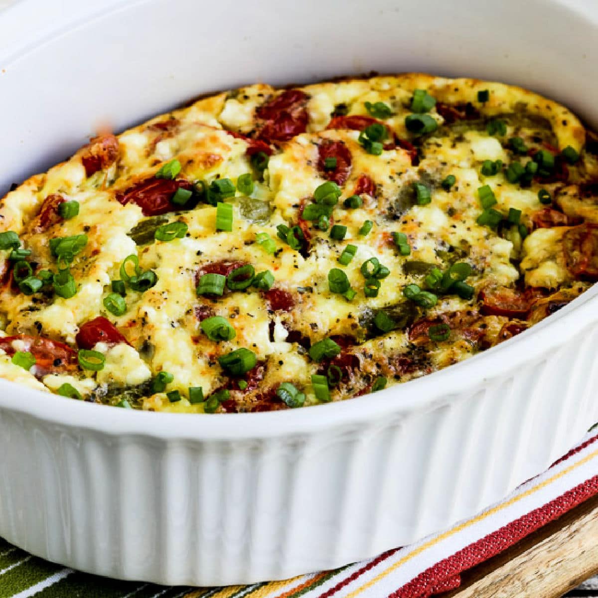 Square image for Vegetable Egg Bake with Peppers, Tomatoes, and Feta shown in baking dish.
