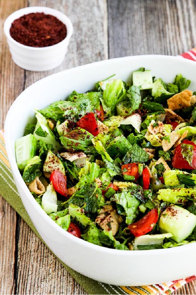 Fattoush Lebanese Salad close-up of finished salad in serving bowl with Sumac in background.