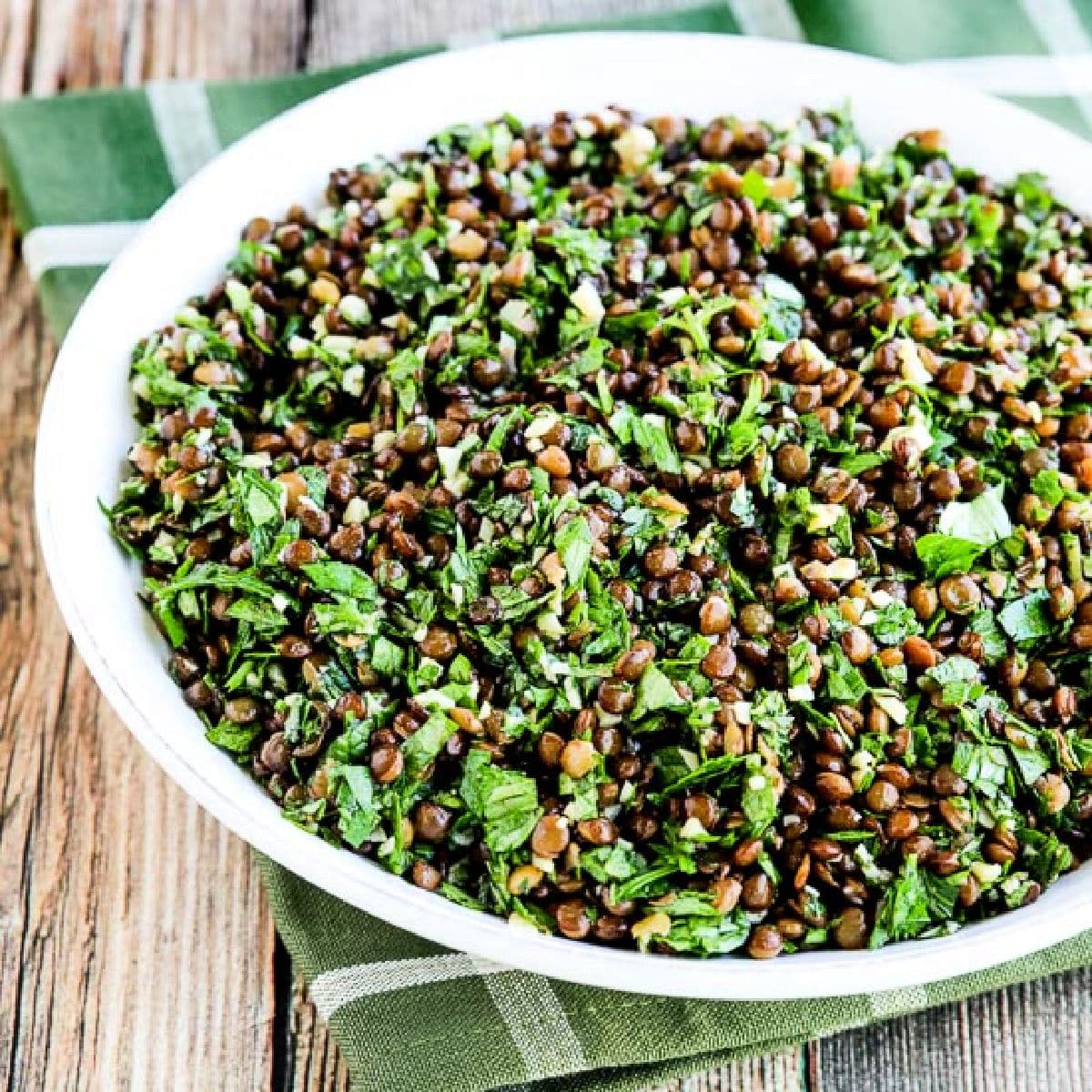Square image for Lebanese Lentil Salad shown on serving plate.