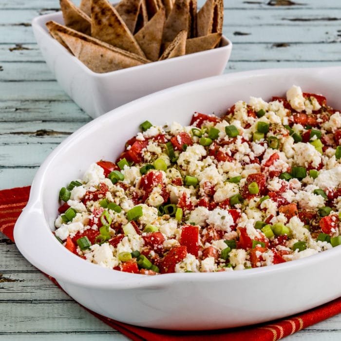 Greek Dip with Tomatoes and Feta thumbnail image of finished dip in serving dish with Pita