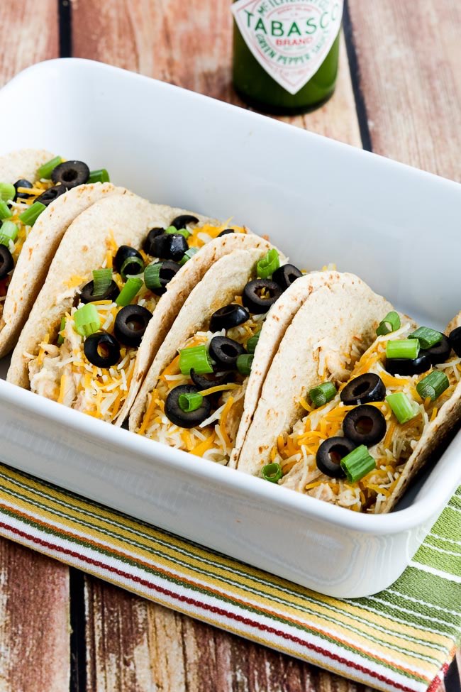 Instant Pot Cheesy Chicken Tacos finished tacos in serving dish.