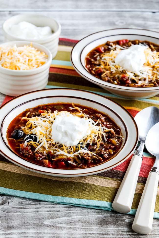 Instant Pot Ground Beef Olive Lover's Chili finished chili in serving bowls with toppings