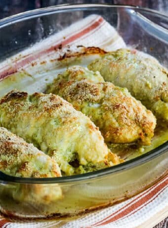 square image of Baked Chicken Stuffed with Pesto and Cheese in baking dish