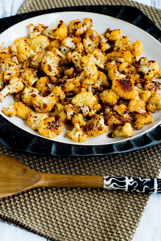 Roasted Spicy Cauliflower on serving plate with black-shite fork