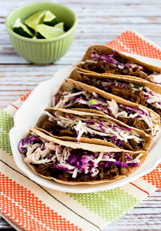Flank Steak Tacos on plate served with spicy Mexican Slaw and lime wedges